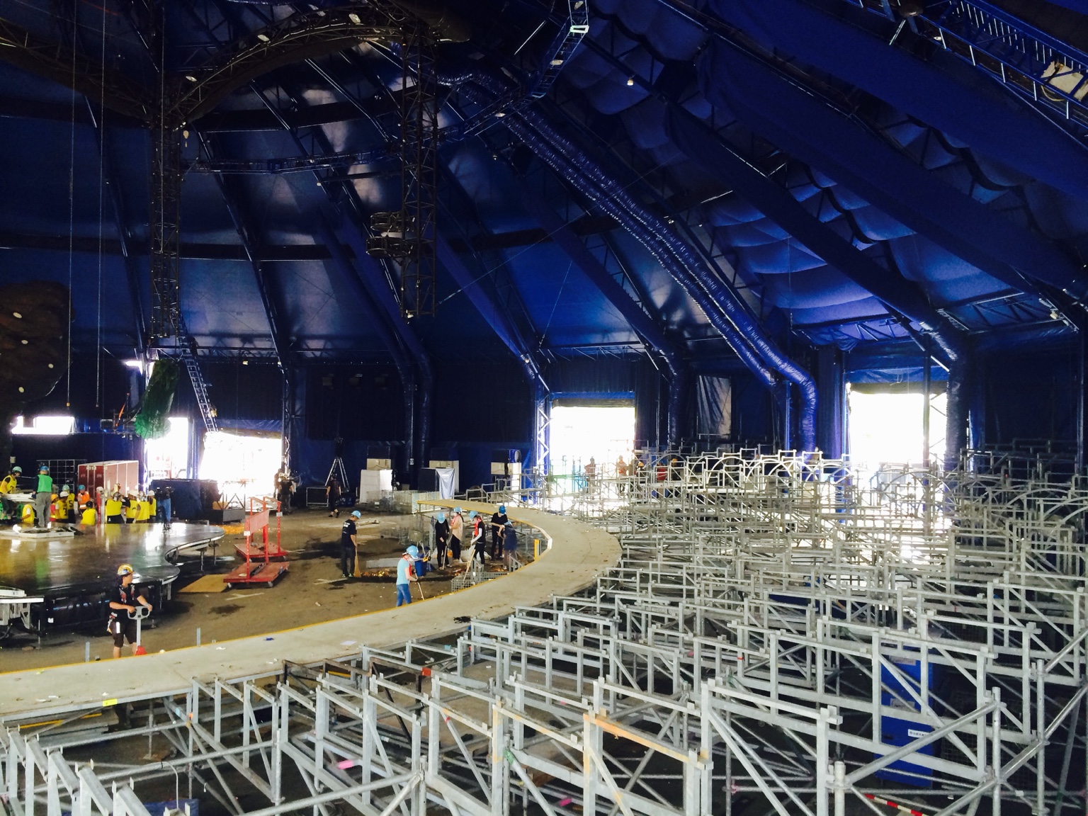 Tiered seating structures being assembled inside a big top