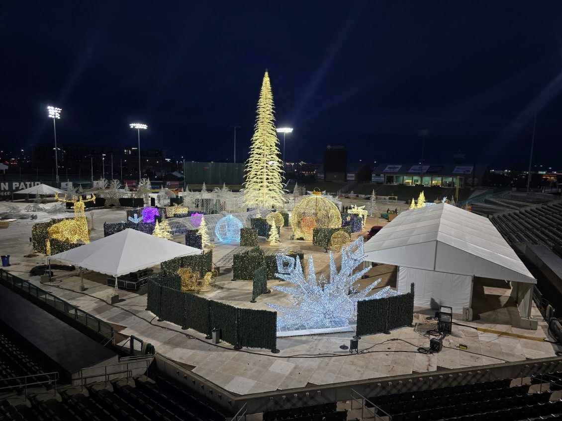 Enchant Lite light maze and tall illuminated tree installed on a stadium field