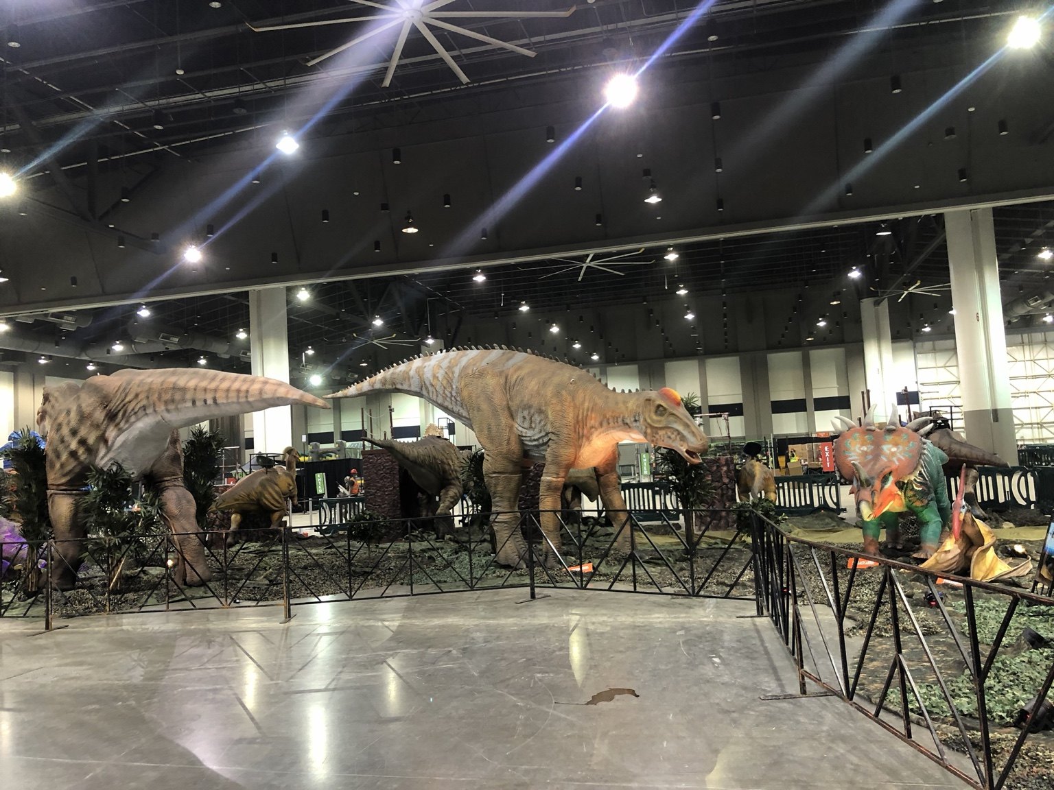 Wide view of Jurassic Quest dinosaur displays and visitor pathways inside an exhibition hall
