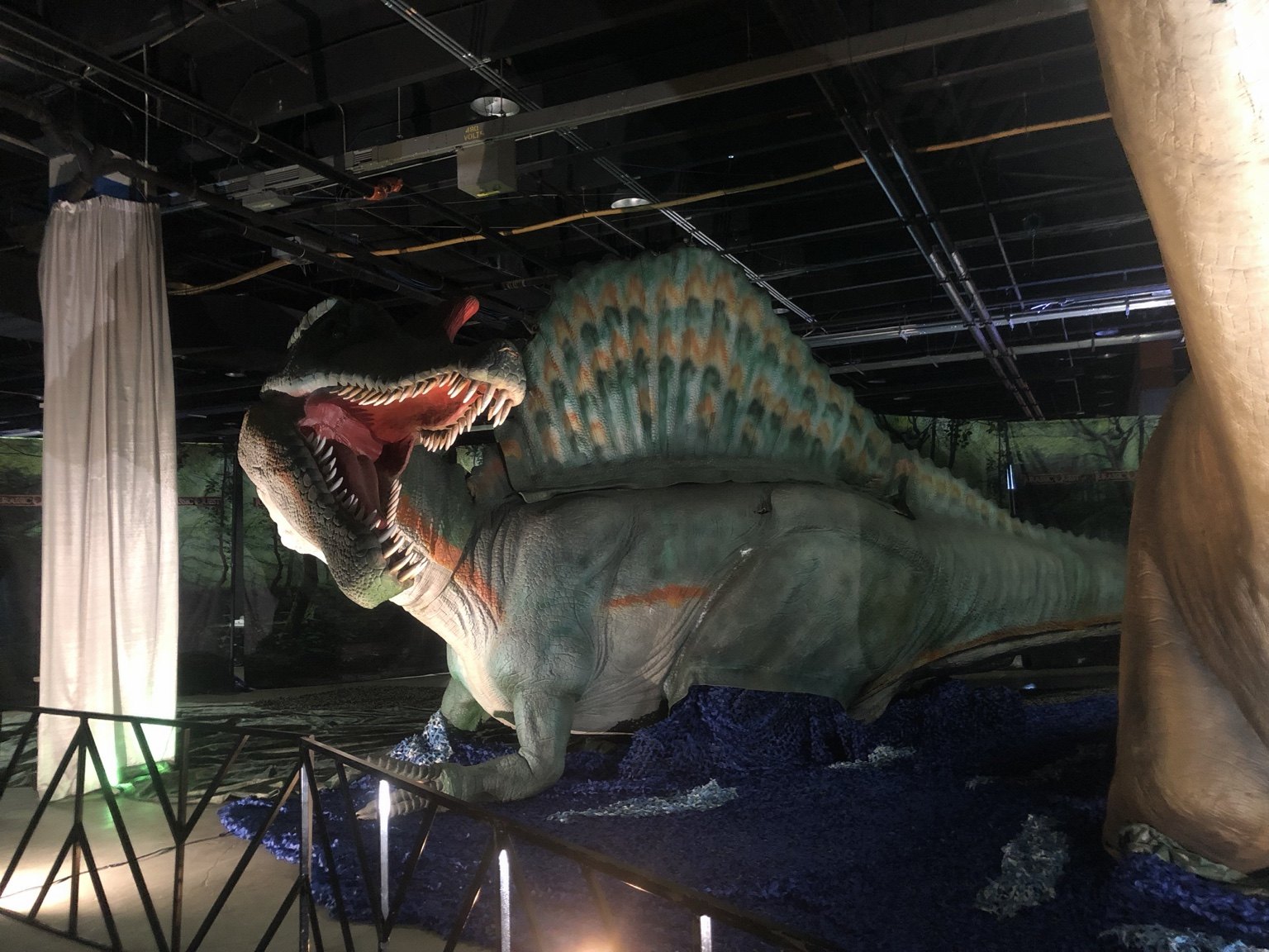 Large Spinosaurus display with scenic surroundings inside Jurassic Quest
