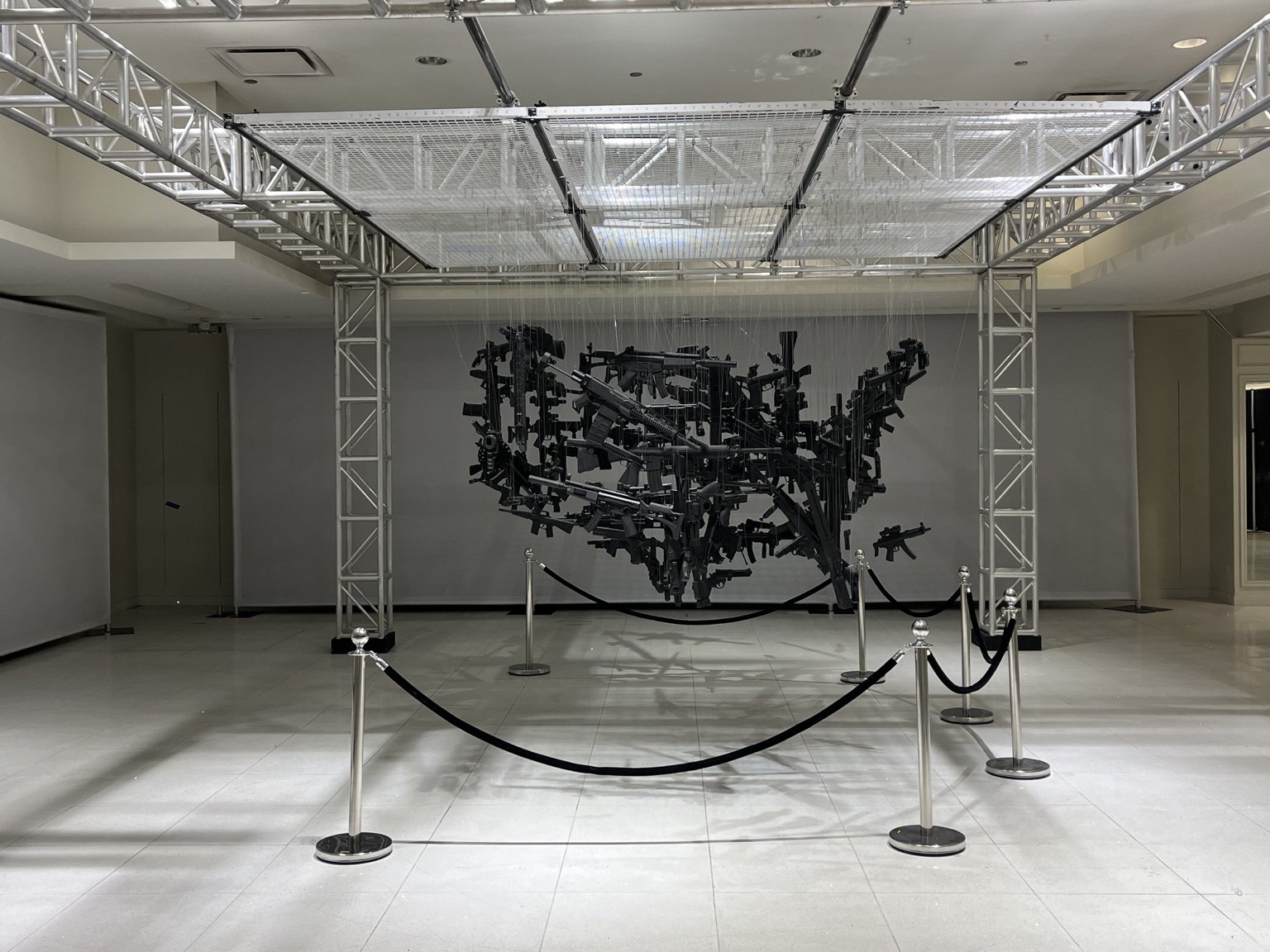 Suspended black elements align to form a map of America
