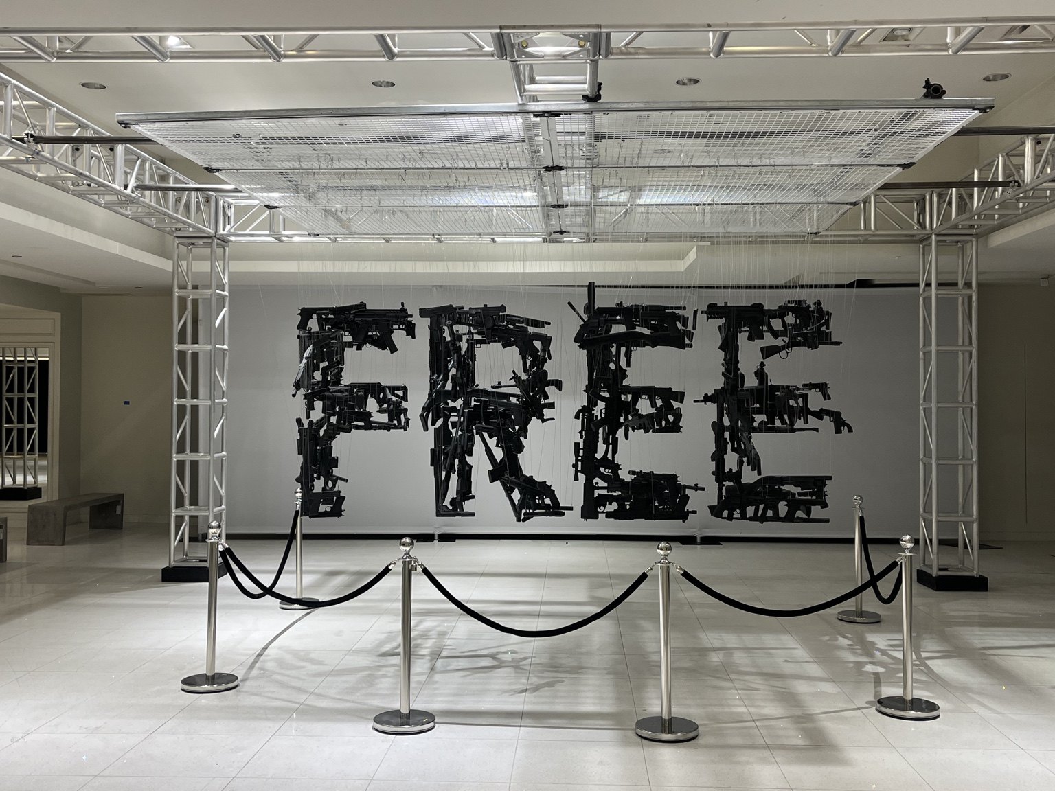 Suspended black elements align to spell FREE