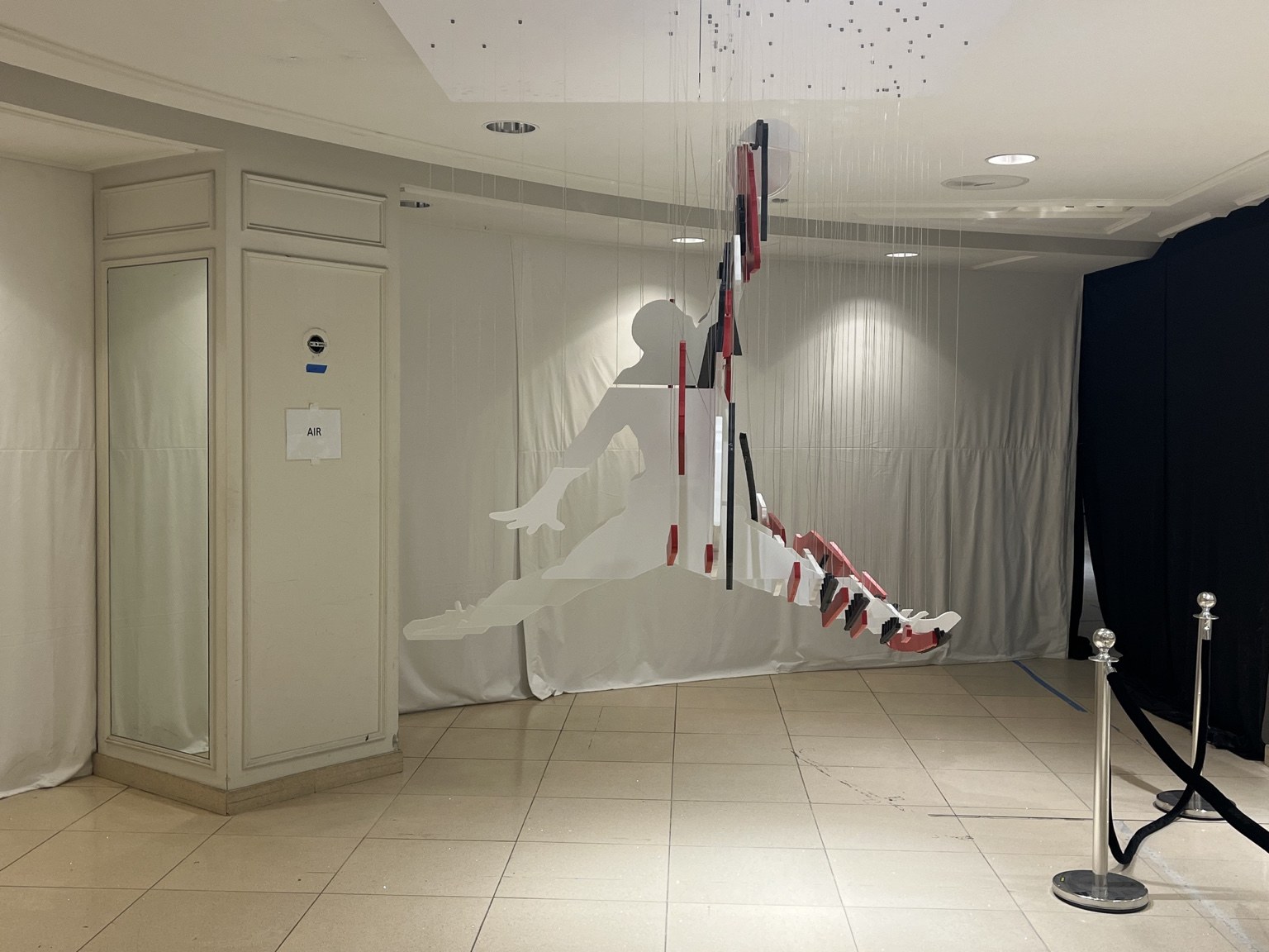 The same suspended artwork viewed from the side forms the Jumpman silhouette