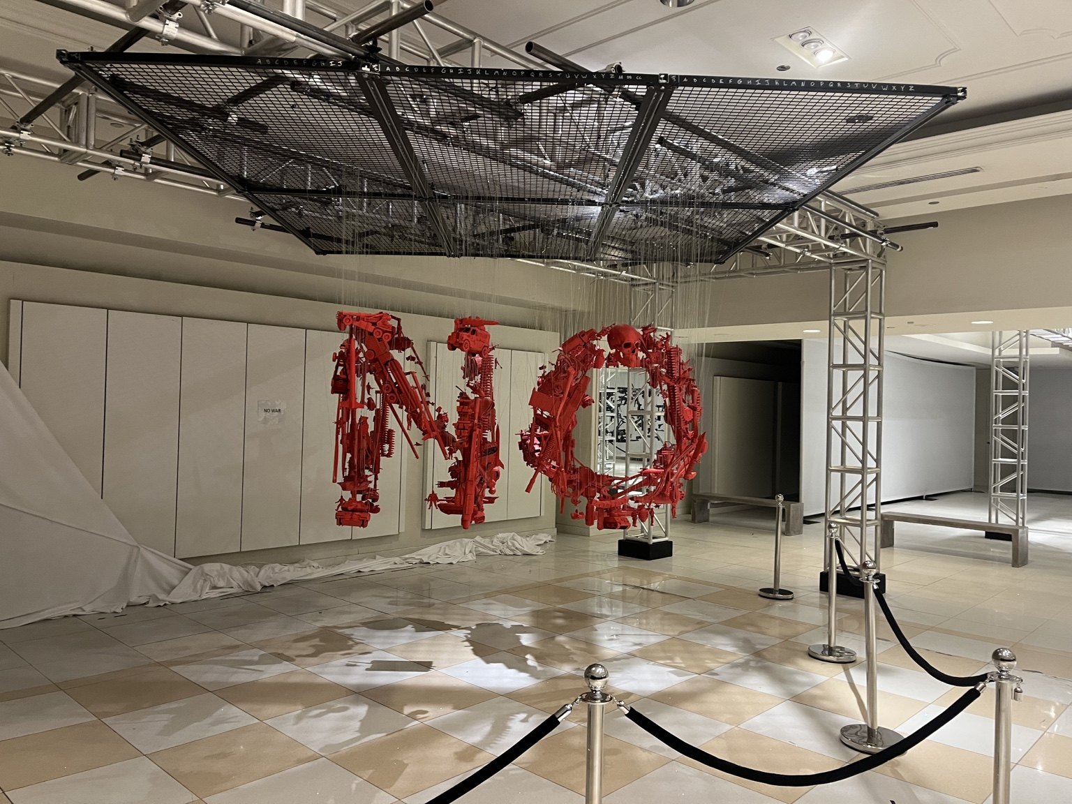Red suspended elements align to spell NO