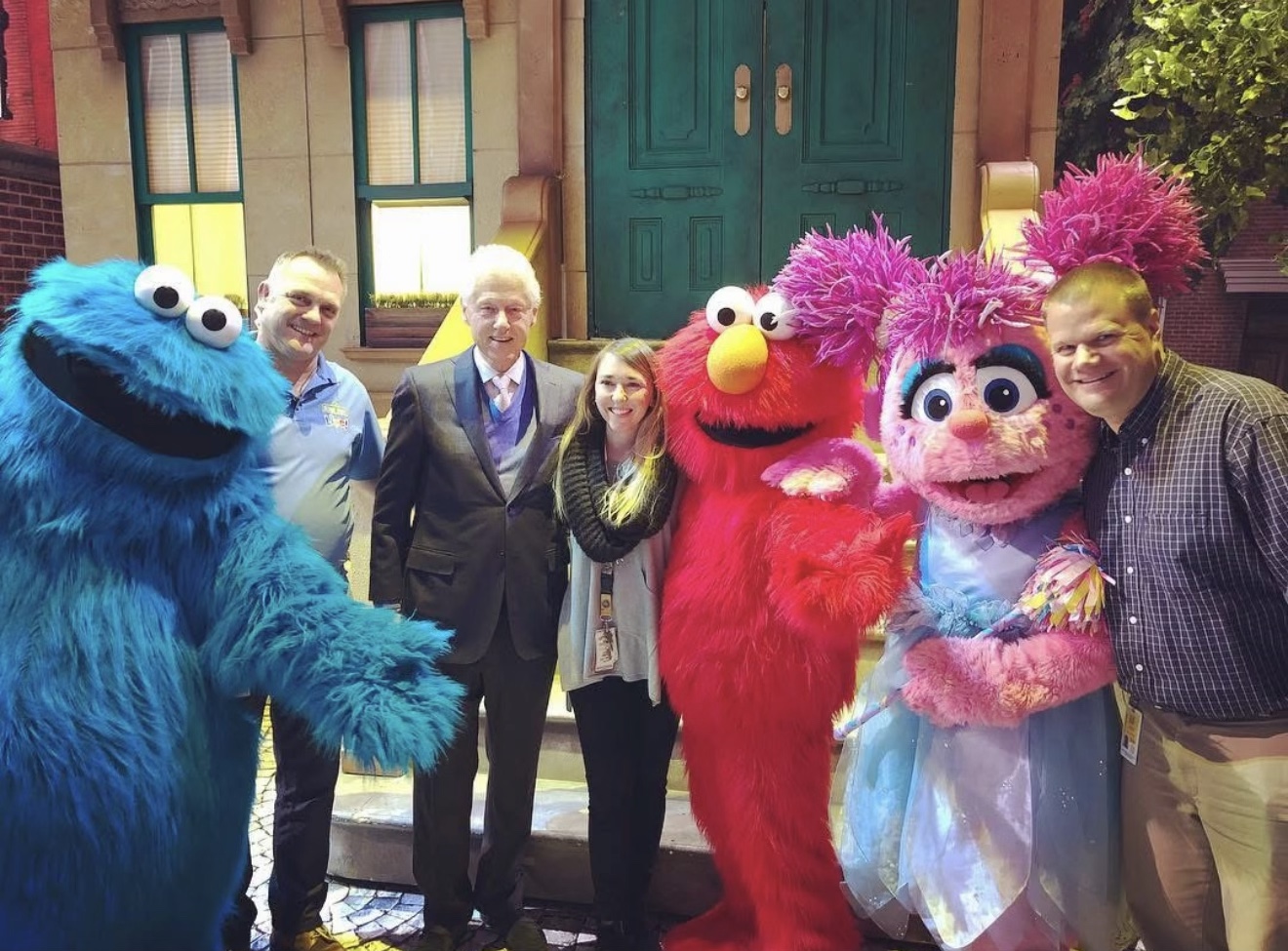 President Bill Clinton with a group and Sesame Street characters Cookie Monster, Elmo and Abby Cadabby during a New York City show visit