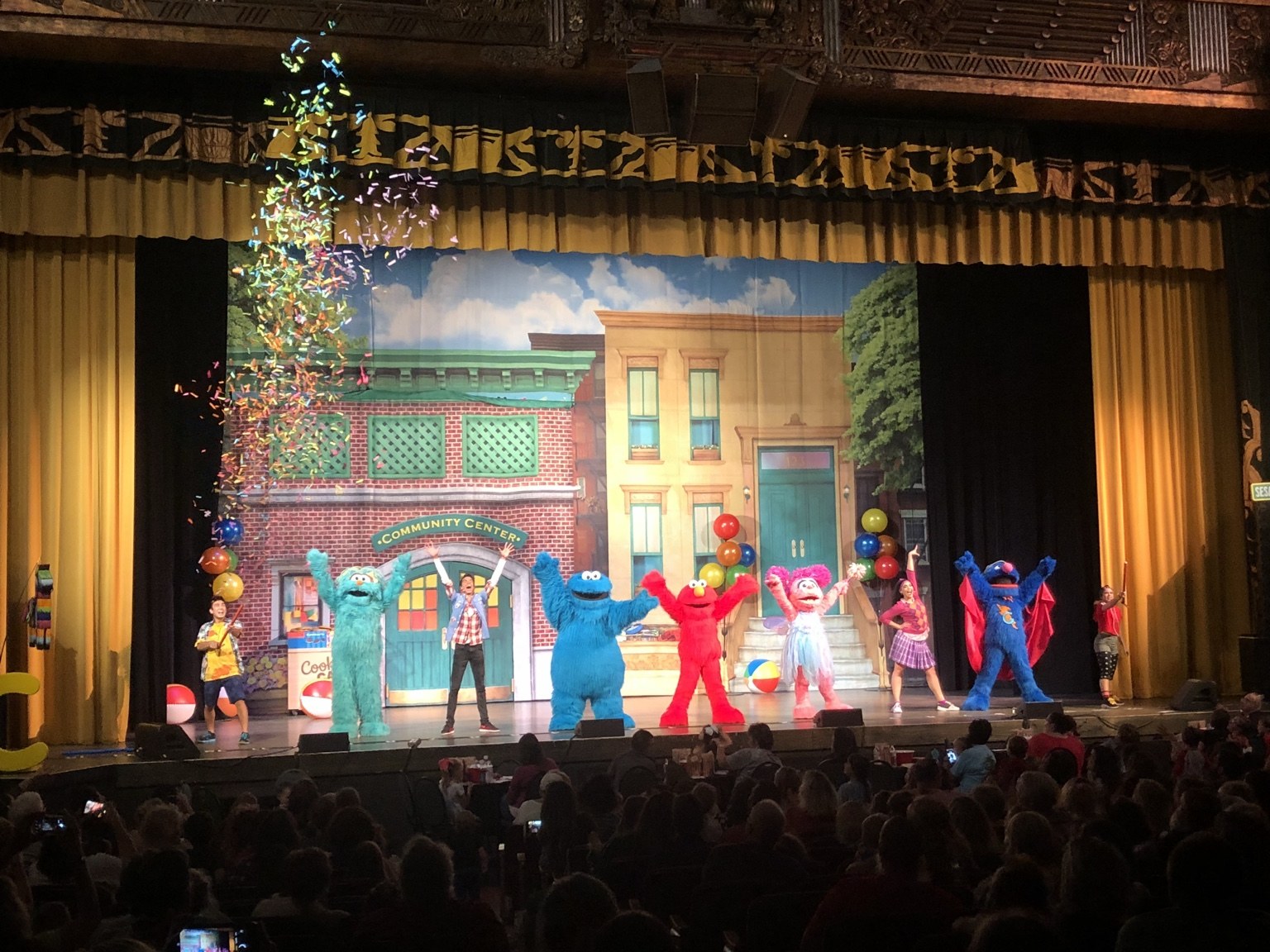 Sesame Street Live cast performing on a theatre stage