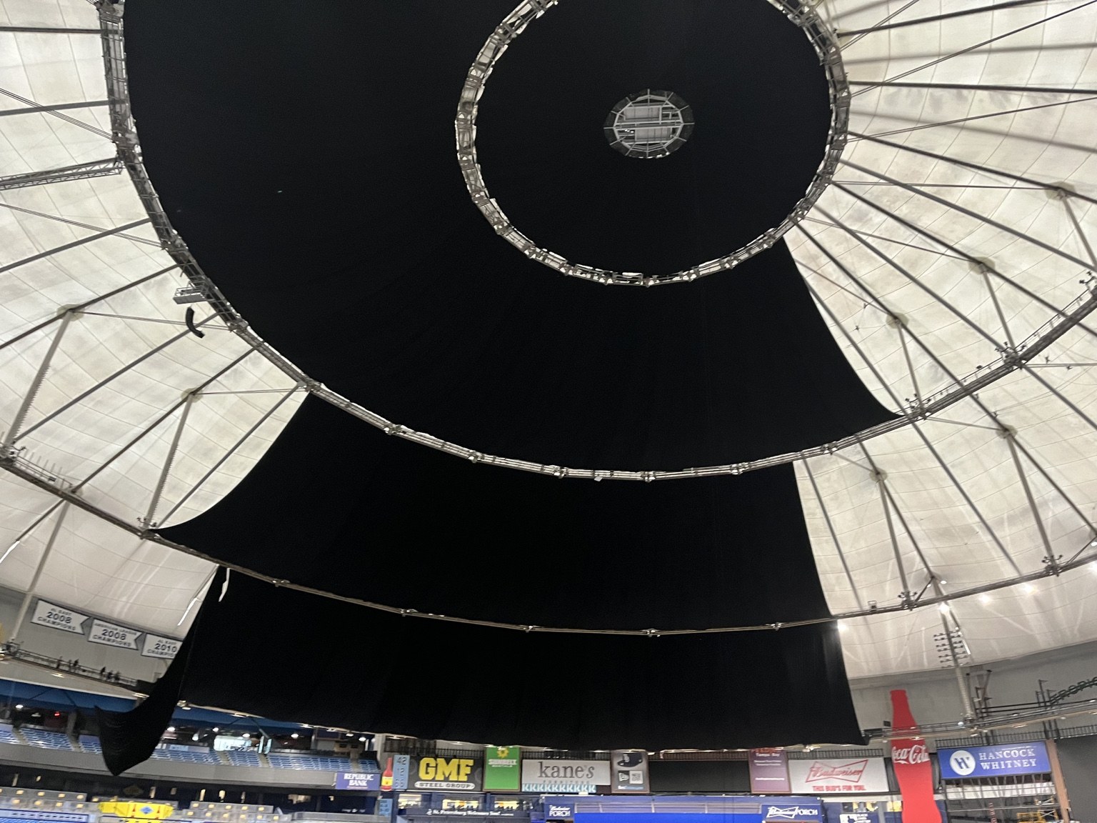 Multiple sections of blackout fabric installed across the stadium roof