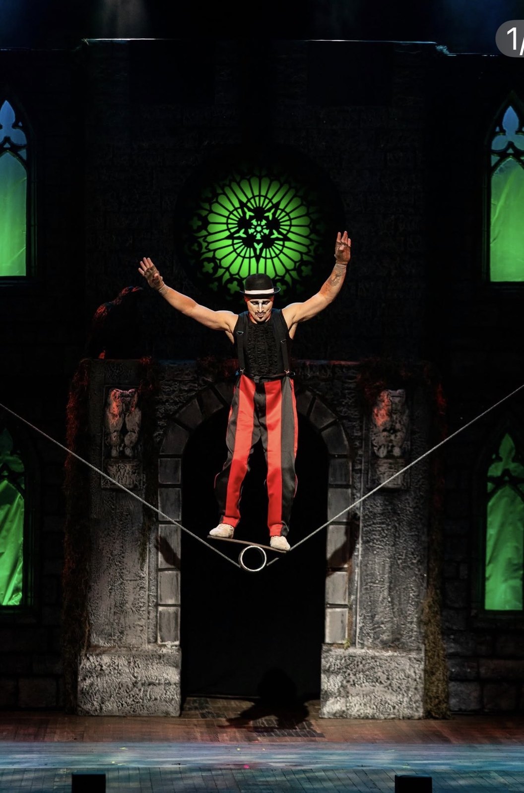 The Vampire Circus performer balancing on a wire in front of Gothic scenery